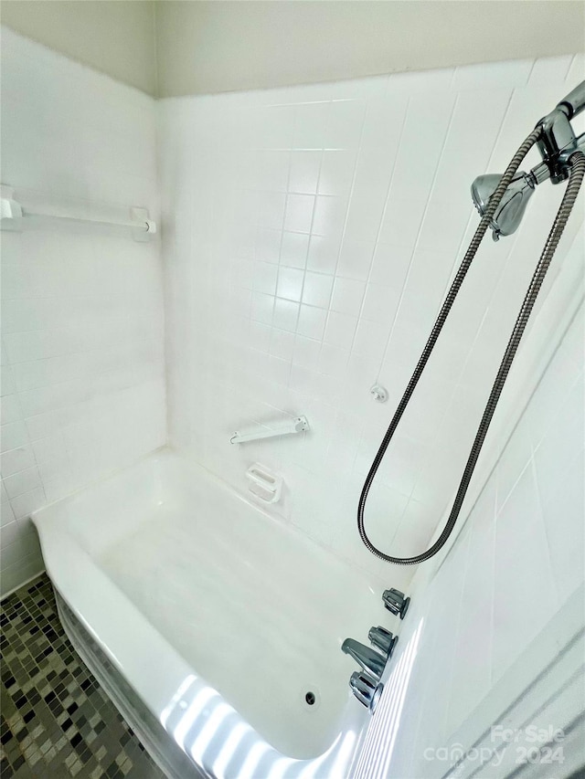 bathroom featuring tile patterned floors and a tile shower