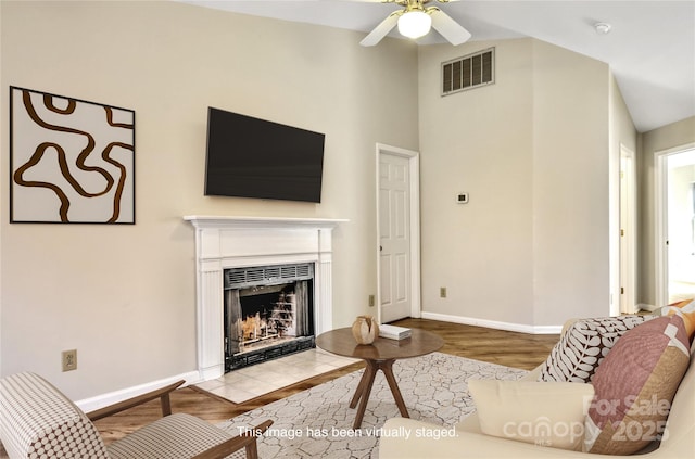 living room featuring light hardwood / wood-style flooring and ceiling fan