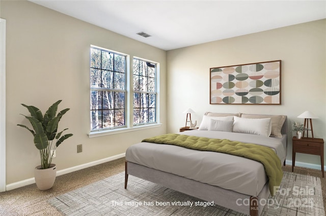 carpeted bedroom featuring multiple windows