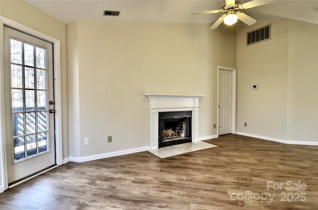 unfurnished living room featuring wood-type flooring and ceiling fan