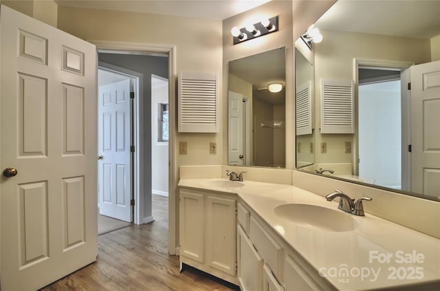 bathroom featuring vanity, radiator, and hardwood / wood-style floors