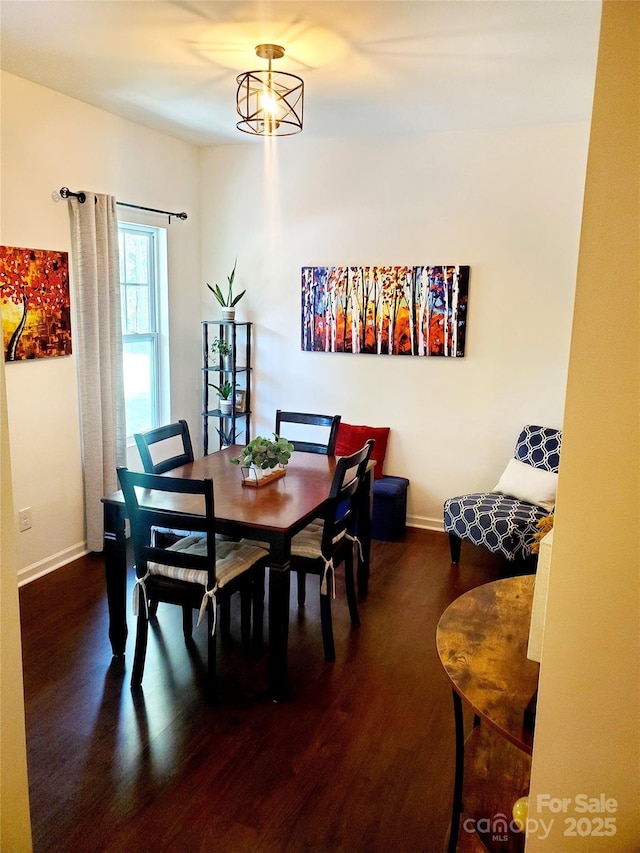 dining space with wood finished floors and baseboards