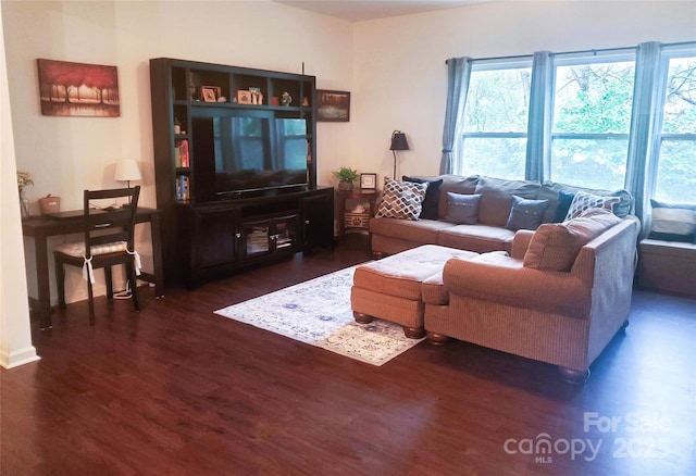living room with wood finished floors and baseboards
