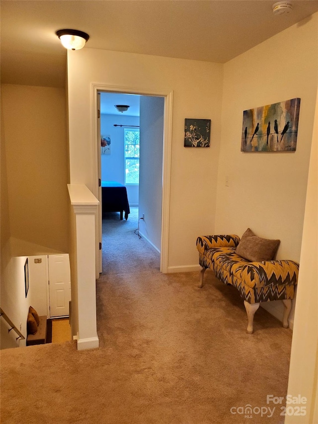 hallway with carpet flooring and baseboards