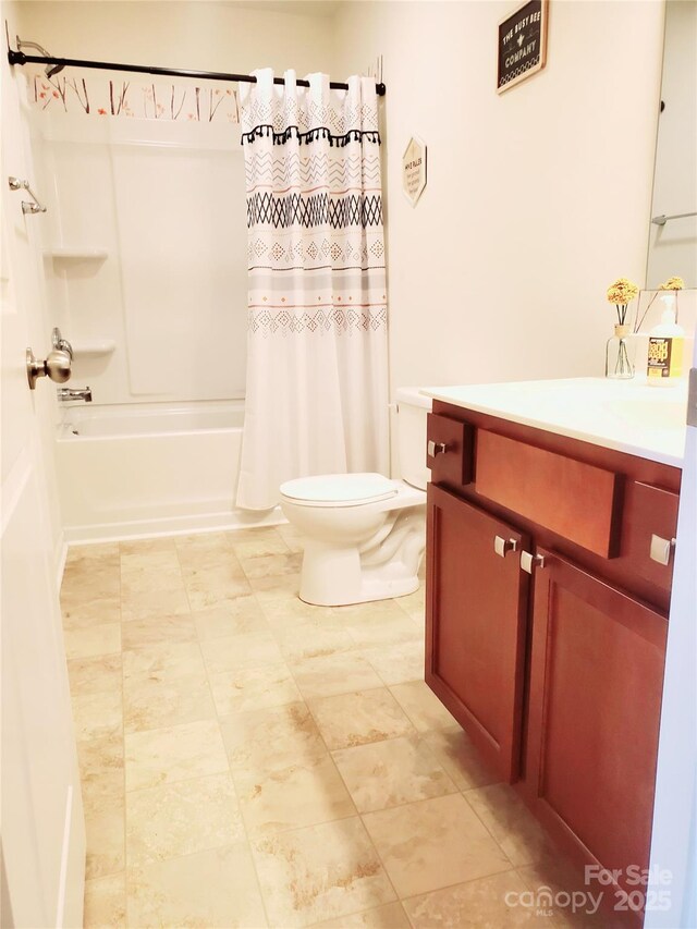 bathroom featuring toilet, vanity, and shower / bath combo with shower curtain