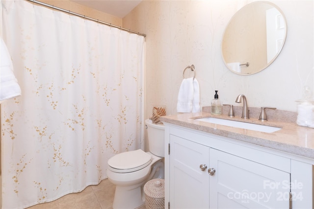 bathroom featuring tile patterned floors, vanity, and toilet