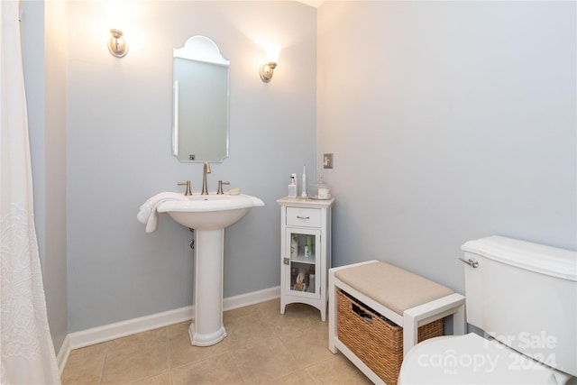 bathroom with toilet and tile patterned floors