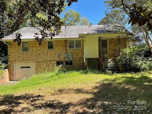 rear view of property with a garage