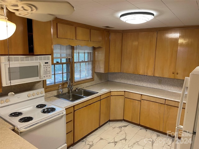 kitchen featuring white appliances and sink