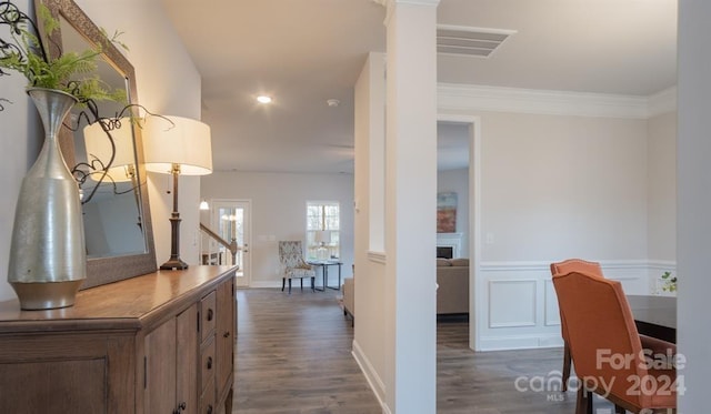 hall featuring dark hardwood / wood-style floors and ornamental molding