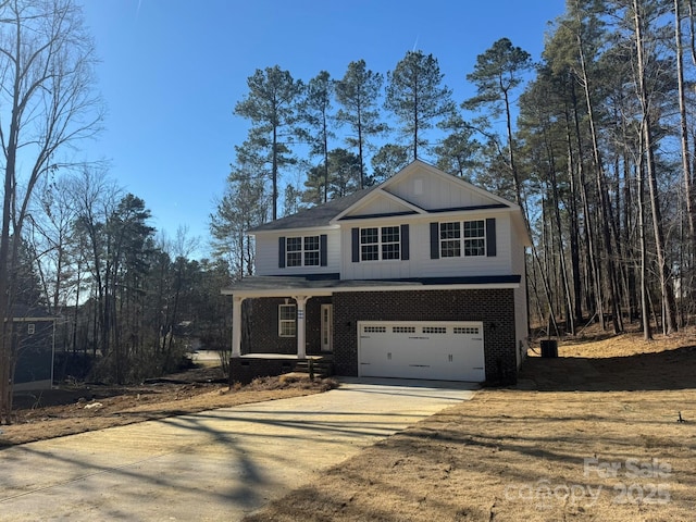 view of property featuring a garage and covered porch