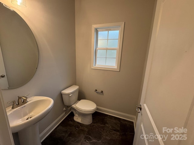 bathroom featuring toilet and sink