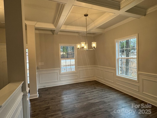 unfurnished dining area featuring an inviting chandelier, beam ceiling, dark hardwood / wood-style floors, coffered ceiling, and ornamental molding