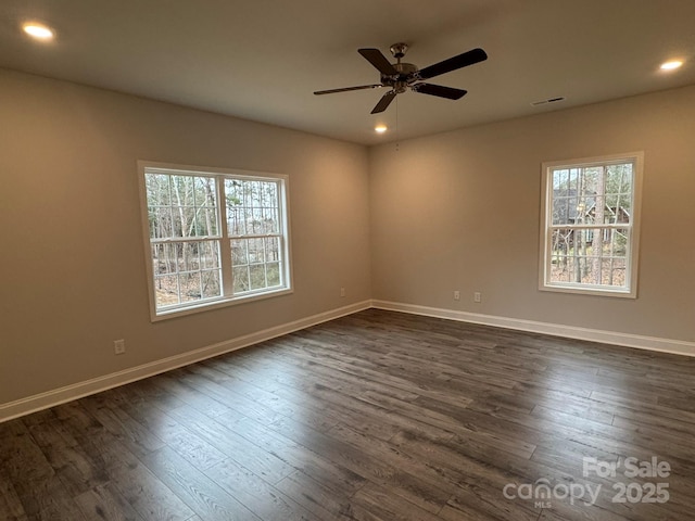 empty room featuring dark wood-type flooring and ceiling fan