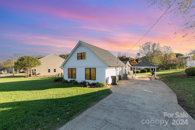 modern inspired farmhouse with a yard and a carport