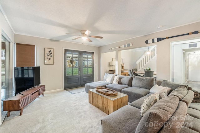 carpeted living room featuring a textured ceiling and ceiling fan