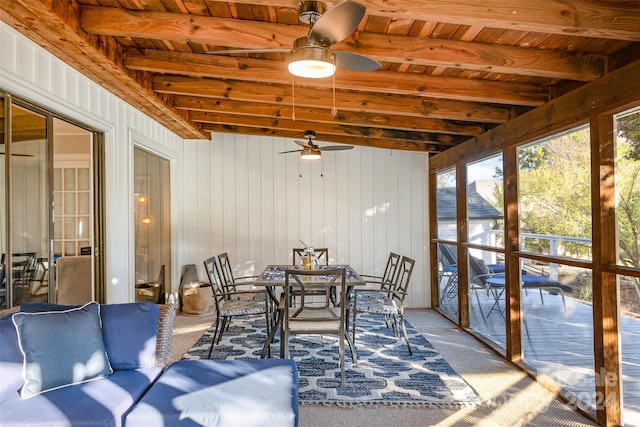 sunroom / solarium with vaulted ceiling with beams, ceiling fan, and wooden ceiling