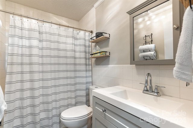 bathroom featuring vanity, backsplash, toilet, a textured ceiling, and tile walls