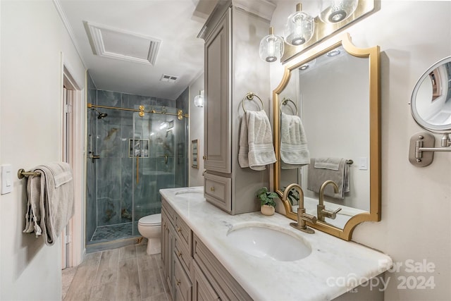 bathroom with vanity, hardwood / wood-style flooring, toilet, and a shower with door