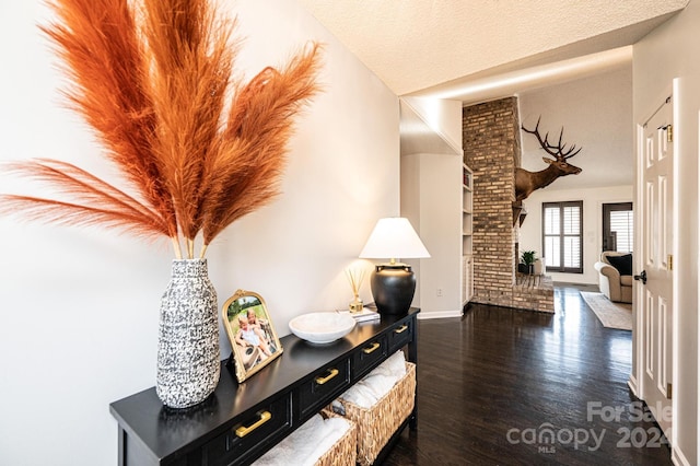 hallway with dark hardwood / wood-style flooring and a textured ceiling