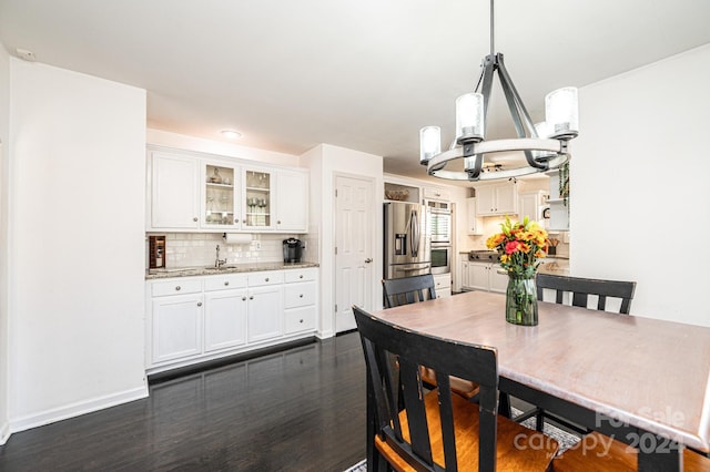 dining space with dark wood-type flooring and sink