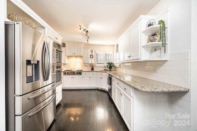 kitchen featuring white cabinetry, light stone countertops, sink, dark hardwood / wood-style floors, and appliances with stainless steel finishes