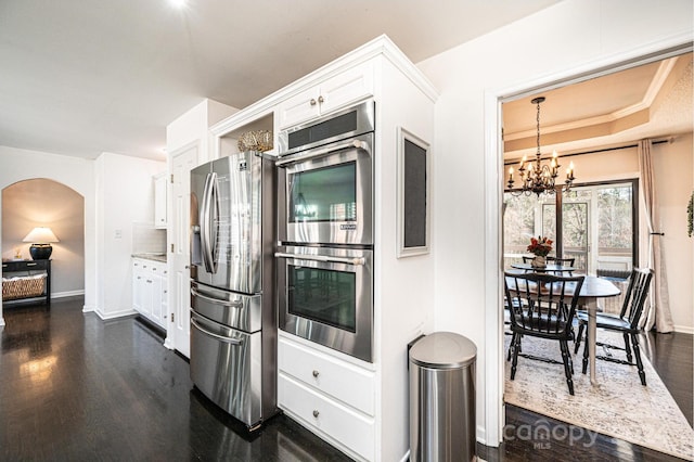 kitchen featuring white cabinetry, an inviting chandelier, dark hardwood / wood-style floors, and appliances with stainless steel finishes