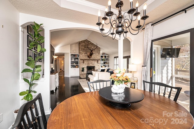 dining space with a brick fireplace, built in features, dark hardwood / wood-style floors, a textured ceiling, and lofted ceiling