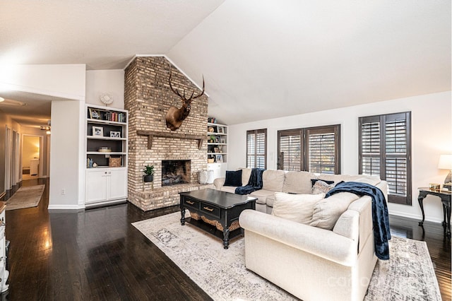 living room featuring built in features, high vaulted ceiling, dark hardwood / wood-style floors, and a brick fireplace