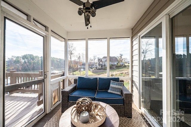 sunroom / solarium featuring ceiling fan