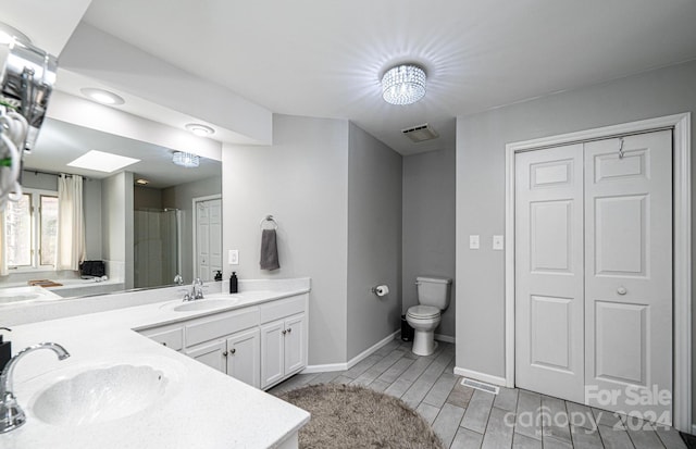 bathroom with vanity, toilet, and walk in shower