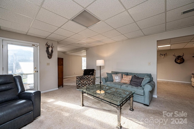 living room with carpet flooring and a drop ceiling