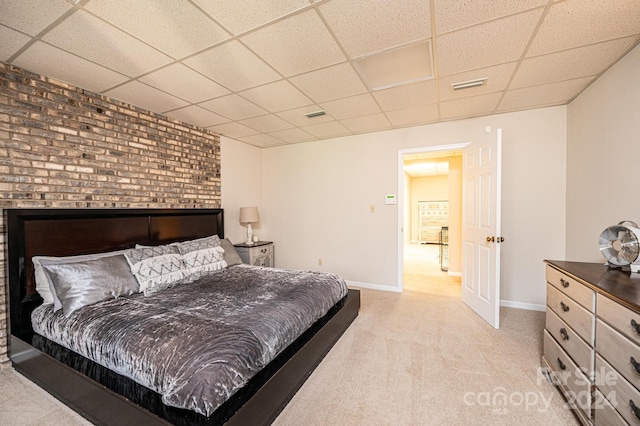 bedroom featuring a paneled ceiling and light colored carpet