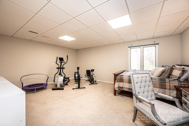 bedroom featuring a paneled ceiling and carpet floors