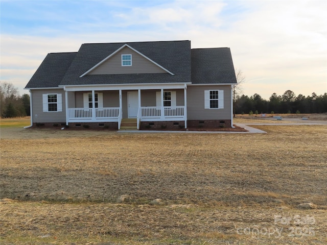 view of front of property with covered porch and a lawn