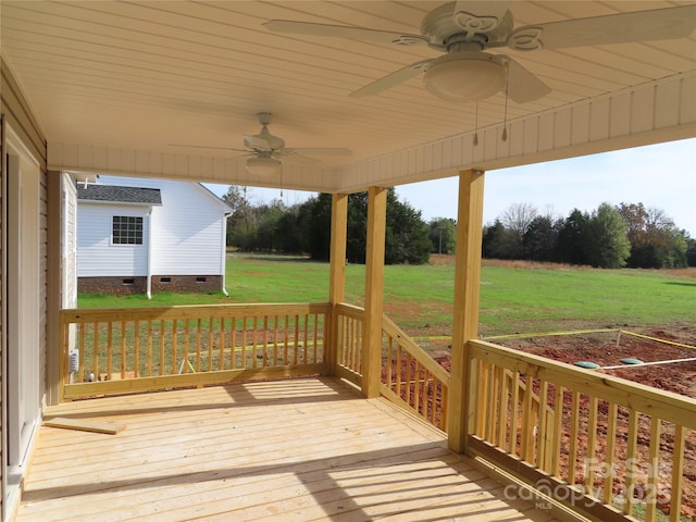 deck featuring a yard and ceiling fan