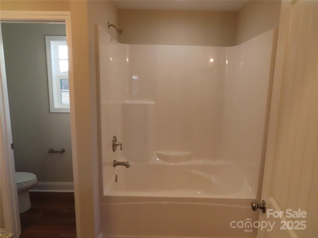 bathroom featuring toilet and shower / bathing tub combination