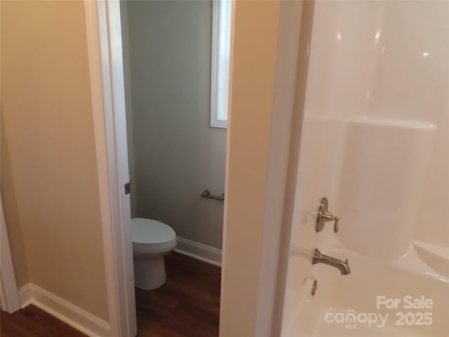 bathroom with wood-type flooring and toilet