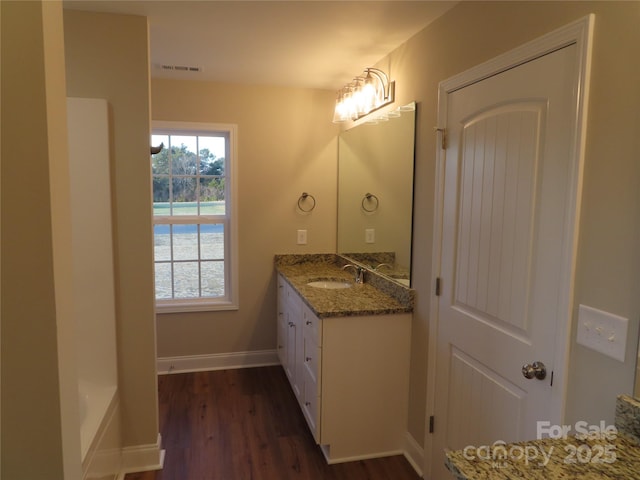 bathroom with vanity and hardwood / wood-style floors