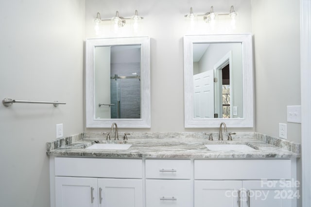 bathroom with vanity and a shower with shower door