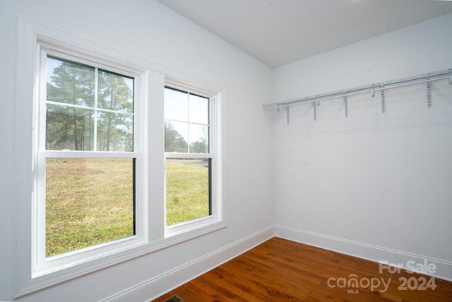 walk in closet with hardwood / wood-style floors