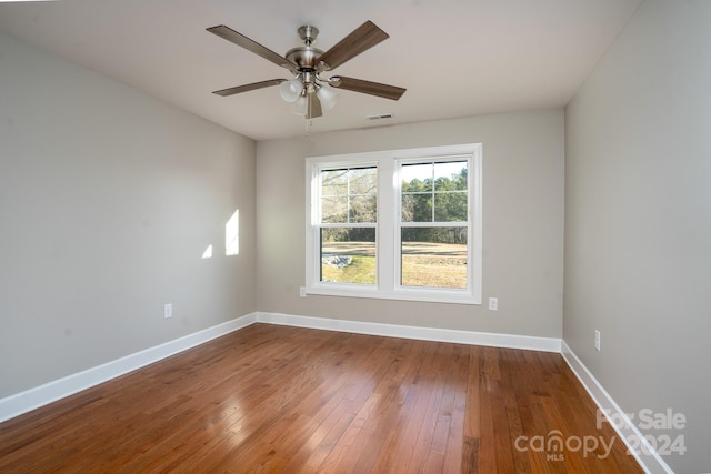 spare room with ceiling fan and wood-type flooring