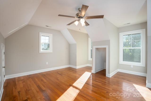 additional living space featuring light wood-type flooring, ceiling fan, and lofted ceiling