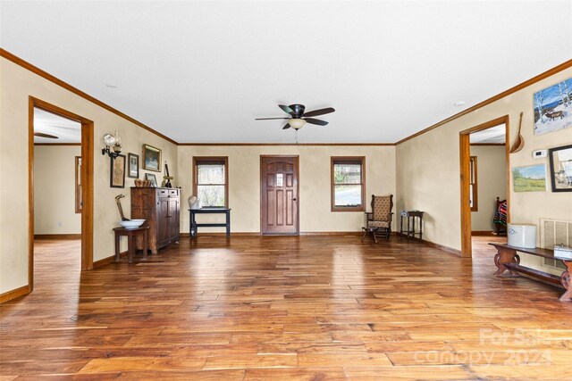 interior space with ceiling fan, light hardwood / wood-style floors, and ornamental molding