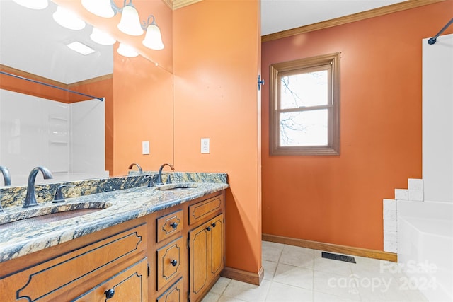 bathroom featuring crown molding, tile patterned flooring, and vanity