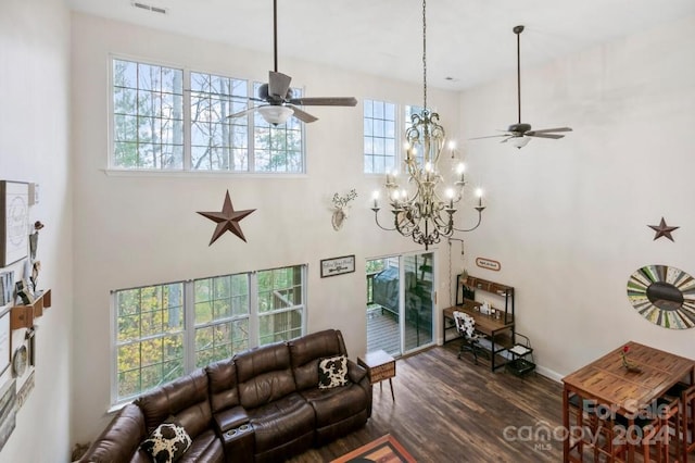 living room with ceiling fan with notable chandelier, dark hardwood / wood-style floors, and plenty of natural light