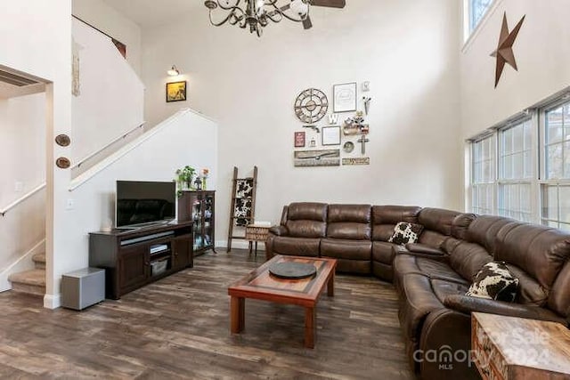 living room featuring dark wood-type flooring and a high ceiling