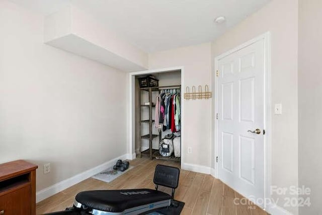 workout room featuring light wood-type flooring