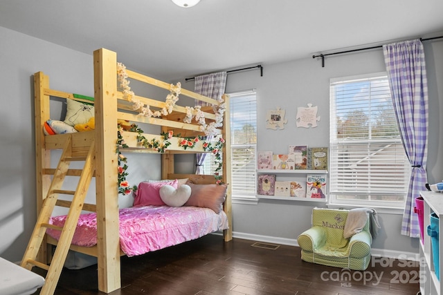 bedroom featuring baseboards, visible vents, and hardwood / wood-style floors