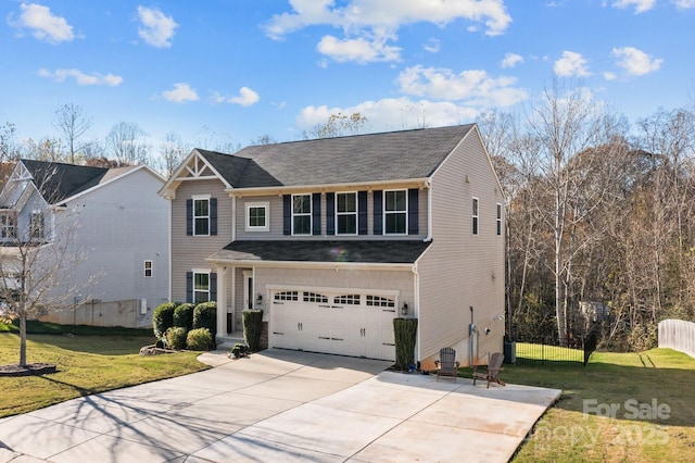 view of front of house with an attached garage, fence, concrete driveway, and a front yard